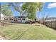 Charming home with a well-maintained front yard, fenced perimeter, and mature trees at 1509 Stone Gate Ln, Atlanta, GA 30317