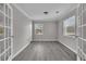 Well-lit office with new flooring, a window, french doors, and fresh paint at 1509 Stone Gate Ln, Atlanta, GA 30317