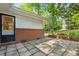 Stone patio with brick accents and access to a well-manicured backyard at 3700 Sexton Woods Dr, Chamblee, GA 30341