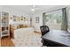 Bright bedroom with hardwood floors, natural lighting and a desk area at 3700 Sexton Woods Dr, Chamblee, GA 30341