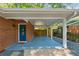 Covered carport with blue painted floor leading to the home's front door and a fenced backyard at 3700 Sexton Woods Dr, Chamblee, GA 30341