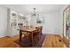 Dining room with a modern light fixture, built-in bar, and access to the outdoor space at 3700 Sexton Woods Dr, Chamblee, GA 30341