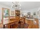Dining room featuring hardwood floors, modern lighting, and an easy flow to the living room at 3700 Sexton Woods Dr, Chamblee, GA 30341