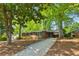 Lovely one-story brick home with blue shutters, a long driveway, and an inviting carport area at 3700 Sexton Woods Dr, Chamblee, GA 30341