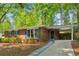 Beautiful brick home featuring a covered carport and a well-manicured lawn and walkway at 3700 Sexton Woods Dr, Chamblee, GA 30341
