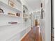 Hallway featuring hardwood floors, built-in shelves, and charming decor at 3700 Sexton Woods Dr, Chamblee, GA 30341