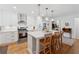 Bright kitchen showcasing an island with seating, stainless steel appliances, and modern pendant lighting at 3700 Sexton Woods Dr, Chamblee, GA 30341