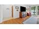 Cozy living room with hardwood floors and large windows, leading to a view of the front yard at 3700 Sexton Woods Dr, Chamblee, GA 30341
