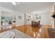 Open-concept living and dining area with hardwood floors, built-in cabinets, and modern lighting fixture at 3700 Sexton Woods Dr, Chamblee, GA 30341