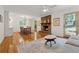 Bright living room featuring a brick fireplace, hardwood floors, and access to the outdoor space at 3700 Sexton Woods Dr, Chamblee, GA 30341