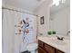 Bathroom with white toilet, stylish shower curtain, and dark wood cabinetry at 3983 Fireoak Dr, Decatur, GA 30032