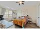 Bright bedroom featuring a ceiling fan, light gray walls, a window with bright, natural light, and dark flooring at 3983 Fireoak Dr, Decatur, GA 30032