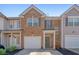 Charming brick townhome featuring an attached garage and manicured landscaping at 3983 Fireoak Dr, Decatur, GA 30032
