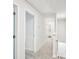 Bright hallway with neutral carpet and white trim, leading to multiple rooms and a bathroom at 4437 Ben Hill Rd, Atlanta, GA 30349