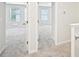 Neutral hallway featuring plush carpeting, white trim, and two visible bedroom doorways at 4437 Ben Hill Rd, Atlanta, GA 30349