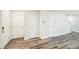 Hallway featuring modern wood-look floors and white trim at 4437 Ben Hill Rd, Atlanta, GA 30349