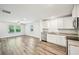 Bright open-concept kitchen with stainless steel appliances and wood-look flooring at 4437 Ben Hill Rd, Atlanta, GA 30349