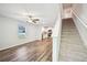 Bright living room with wood floors, stairs, and open kitchen, creating a modern, airy space at 4437 Ben Hill Rd, Atlanta, GA 30349
