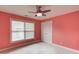 Bedroom featuring a window, ceiling fan, carpet, and neutral blinds, providing a serene and comfortable space at 1633 Park Hollow Ln, Lawrenceville, GA 30043