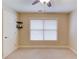 Bedroom with neutral carpet and walls, a ceiling fan, and a large window at 1633 Park Hollow Ln, Lawrenceville, GA 30043