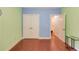 Bright bedroom with blue accent wall and hardwood floors with walk-in closet at 1633 Park Hollow Ln, Lawrenceville, GA 30043