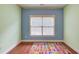 Colorful bedroom featuring hardwood floors, bright paint, and an ABC rug at 1633 Park Hollow Ln, Lawrenceville, GA 30043
