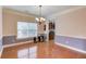 Formal dining room with hardwood floors, chandelier, and view of the kitchen at 1633 Park Hollow Ln, Lawrenceville, GA 30043
