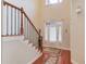 Elegant foyer with wood floors, and a stairway with wooden handrail and metal spindles at 1633 Park Hollow Ln, Lawrenceville, GA 30043