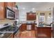Well-equipped kitchen featuring stainless steel appliances, granite counters, and wood cabinets at 1633 Park Hollow Ln, Lawrenceville, GA 30043