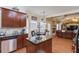 Open kitchen and breakfast nook area features stainless appliances, dark cabinets and granite countertops at 1633 Park Hollow Ln, Lawrenceville, GA 30043