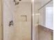Neutral tiled shower stall with a glass enclosure and a shower head, offering a clean and functional design at 1633 Park Hollow Ln, Lawrenceville, GA 30043