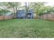 Large fenced backyard featuring a well-maintained lawn and mature trees at 22 Vinson Se Dr, Atlanta, GA 30317
