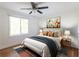 Bright bedroom featuring a bed with colorful pillows, ceiling fan, and hardwood floors at 22 Vinson Se Dr, Atlanta, GA 30317