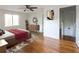 Bright bedroom featuring hardwood floors, a ceiling fan, and a decorative rug at 22 Vinson Se Dr, Atlanta, GA 30317