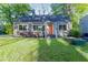 Charming home with a well-manicured lawn and colorful front door at 22 Vinson Se Dr, Atlanta, GA 30317