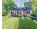 Charming home featuring a manicured lawn, bright orange front door, and inviting curb appeal at 22 Vinson Se Dr, Atlanta, GA 30317
