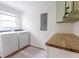 Bright laundry room with modern appliances, built-in cabinets, and butcher block counter at 22 Vinson Se Dr, Atlanta, GA 30317