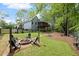 Grassy backyard with a fire pit and seating area at 3450 N Cook Rd, Powder Springs, GA 30127