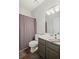 Well-lit bathroom featuring a shower with curtain, toilet, vanity and wood flooring at 3450 N Cook Rd, Powder Springs, GA 30127
