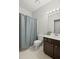 Bathroom featuring a shower with patterned curtain, toilet, and vanity with modern fixtures at 3450 N Cook Rd, Powder Springs, GA 30127