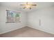 Bright bedroom with large window letting in natural light and neutral carpet flooring at 3450 N Cook Rd, Powder Springs, GA 30127