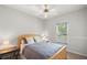 Cozy bedroom features a ceiling fan, window with blinds, and neutral decor, creating a serene atmosphere at 3450 N Cook Rd, Powder Springs, GA 30127