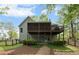 Rear exterior view of home with a upper level deck and a covered patio at 3450 N Cook Rd, Powder Springs, GA 30127