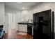 Spacious kitchen showcasing dark countertops, cabinetry, and a view of the staircase and other interior at 3450 N Cook Rd, Powder Springs, GA 30127