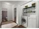 Convenient laundry area with washer, dryer, shelving, and easy access to other areas of the home at 3450 N Cook Rd, Powder Springs, GA 30127