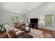 Spacious living room with hardwood floors, large windows, and cozy seating arrangement at 3450 N Cook Rd, Powder Springs, GA 30127