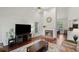 Bright living room with high ceilings, a fireplace, and hardwood floors at 3450 N Cook Rd, Powder Springs, GA 30127