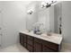 A spacious bathroom featuring double sinks, neutral walls, ample lighting, and decorative mirrors at 3450 N Cook Rd, Powder Springs, GA 30127
