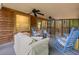 Inviting screened-in porch with wood paneled walls, ceiling fans, and comfortable seating at 3450 N Cook Rd, Powder Springs, GA 30127
