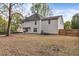 Exterior view of a home showing a spacious backyard with a fence and grill at 404 Foxwood Ct, Mcdonough, GA 30253